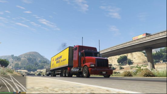 Best GTA 5 mods - a red truck with a yellow cargo hold driving down a freeway.