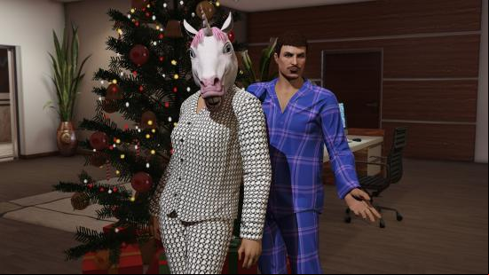 Best Christmas games - a couple in pyjamas standing in an office with a giant Christmas tree. The woman in the light PJs is also wearing a unicorn mask.