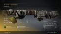 A rifle with an old, cracked gas mask near the barrel