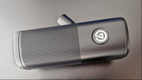 The Elgato Wave DX microphone lying down on top of a gaming desk