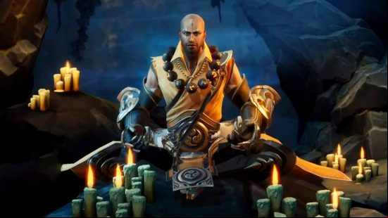 Diablo Immortal tier list: the Monk sitting cross legged in front of numerous burning candles