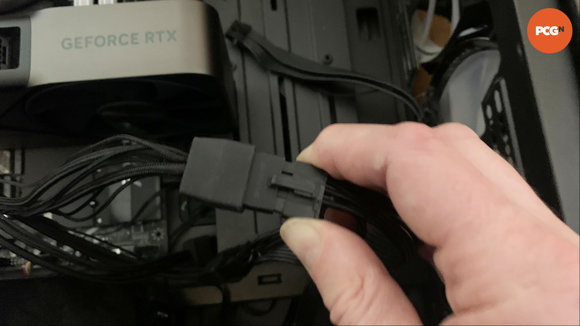 How to install a graphics card: An eight-pin cable being plugged into a 12VHPWR adapter.