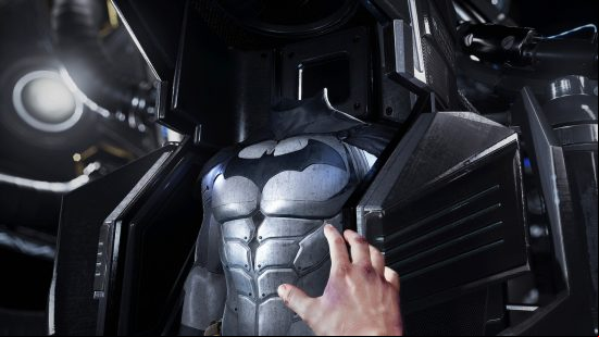 Best Batman games - A hand reaching out for Batman's suit in Batman Arkham VR.