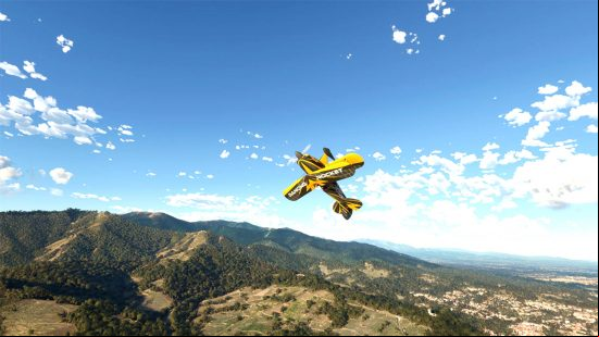 Best VR games - a small yellow airplane doing a somersault above some tree-covered hills in Microsoft Flight Simulator.