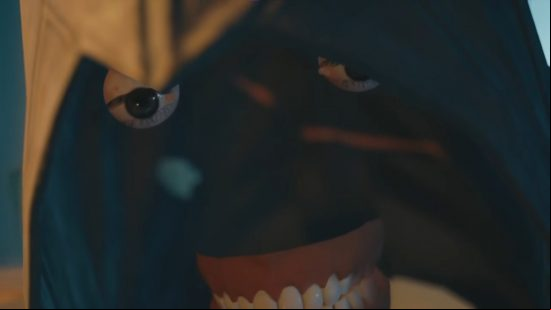 Assassin's Creed Unity face bug sees the skin missing and only the teeth and eyes floating beneath a raised hood