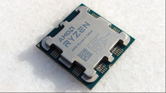 The AMD Ryzen 5 7600X processor lying atop a white stone table