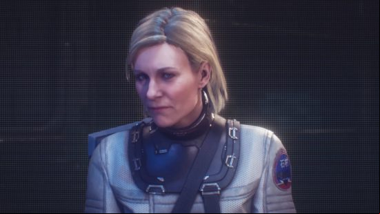 Dead Space cast voice list - a woman with blonde hair sitting down. She's on a screen.