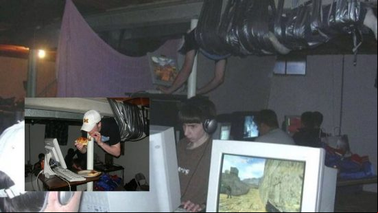 Two boys playing on old computers sellotaped to the ceiling