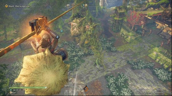 Wild Hearts review - the hunter is using a zipline to launch a sneak attack on the giant boar down below.