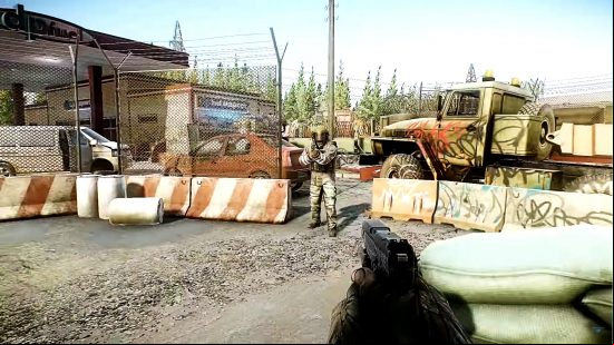 Escape From Tarkov cheaters - first-person view of a player holding a gun looking at another armed person, who is standing between several safety fences around some worn-down cars