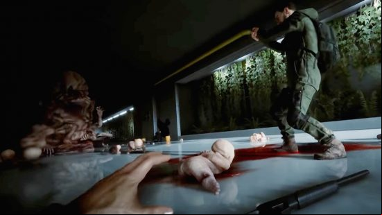 Sons of the Forest mutants: The player lies on the floor, while an NPC shoots at Sluggy, a large, fleshy monster who throws mutant babies in attack