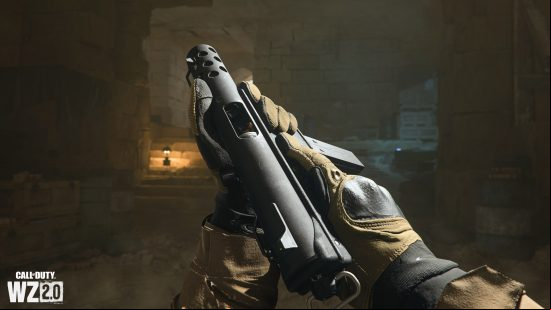 A basic looking machine pistol - the  opens the chamber to check for a round.