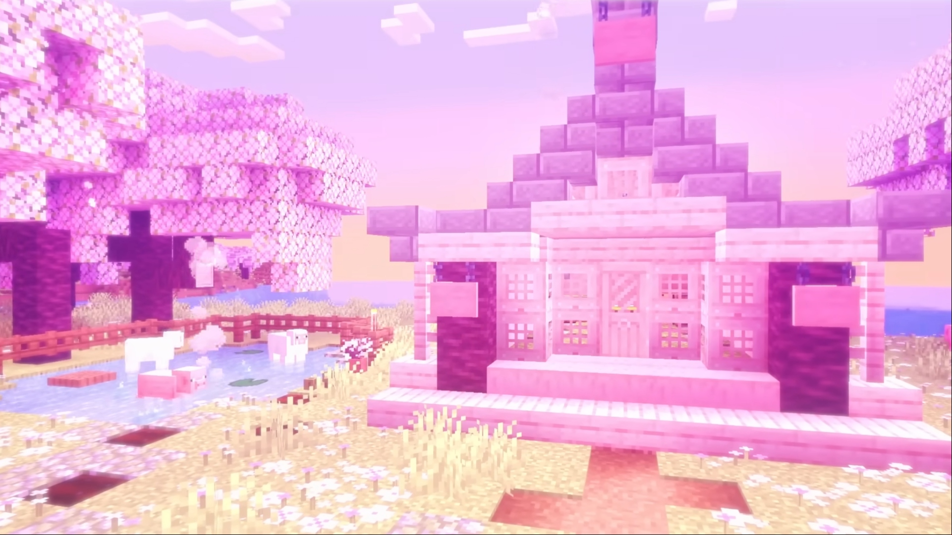 Best cross-platform games: Minecraft. Image shows a house created in the game, surrounded by sheep and cherry blossoms.