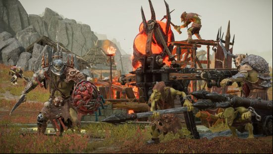 A group of goblins wearing armor firing a catapult on a grassy battlefield