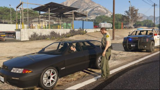 Best GTA 5 mods: a cop has pulled over Michael, who was driving a black car presumably because of his speed.