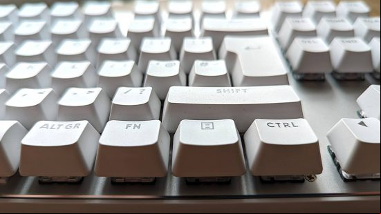 Logitech G Pro X TKL Lightspeed review: a white keyboard appears side on above a wooden worktop.