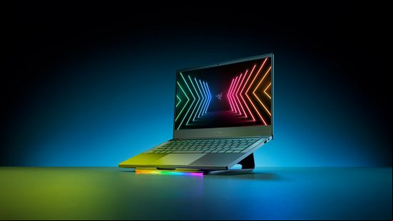 A Razer Blade laptop sat upon an angled plinth with a colorful Razer logo displayed on the screen 