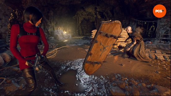 Resident Evil 4 Remake Separate Ways - Ada Wong pulls a shield away from an enemy with her grappling hook.