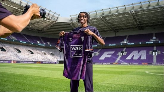 FM24 Saudi Pro League: a football player holds up his shirt after g for a new club.