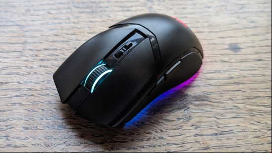 Razer Cobra Pro review: a black mouse with multicolored RGB appears on a wooden surface.