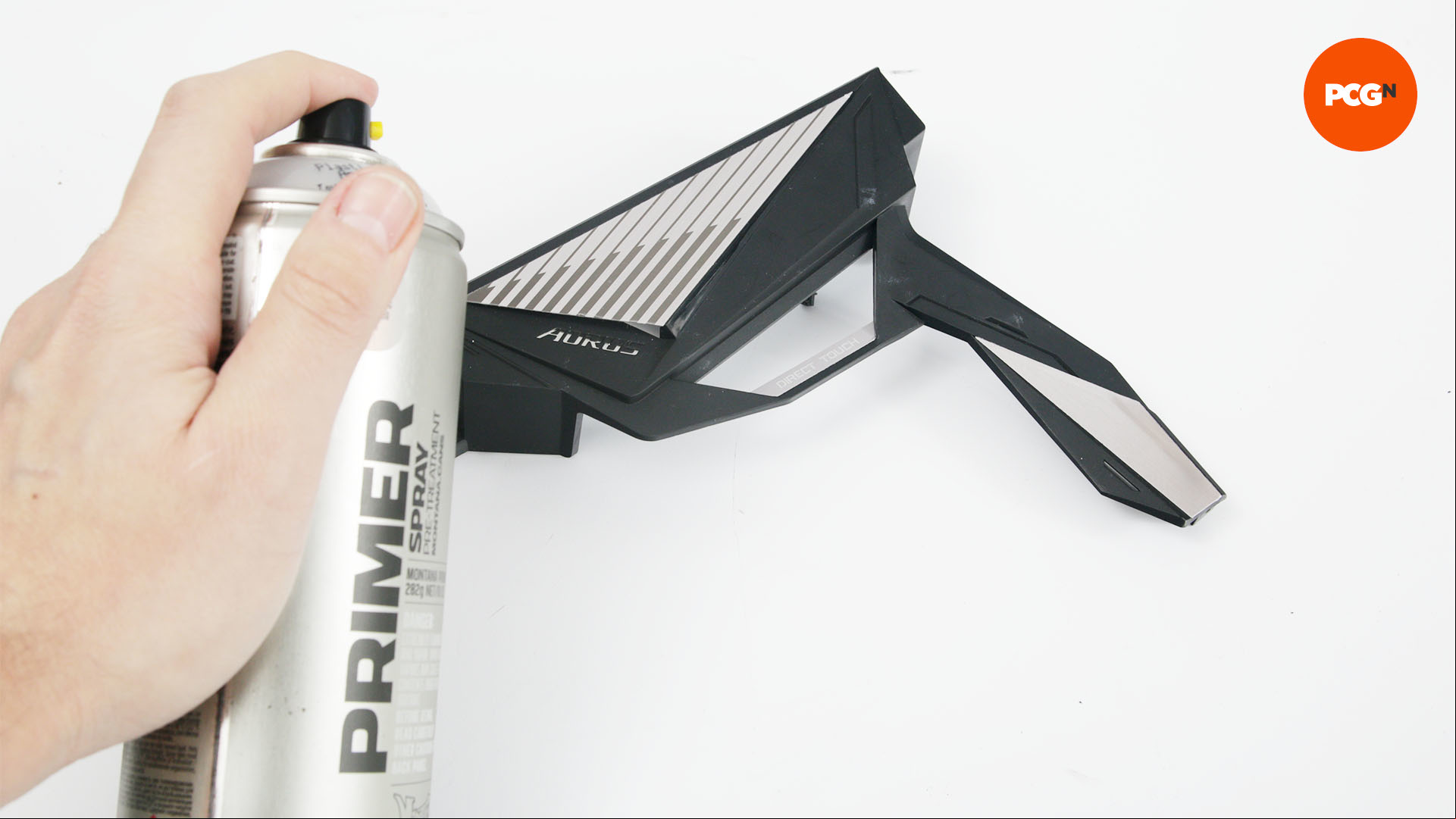 Plastic primer being sprayed onto a heatsink of a motherboard