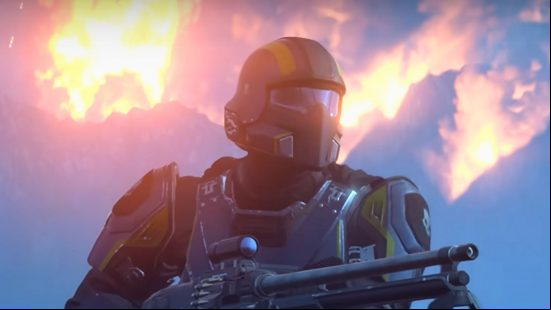 A soldier in Helldivers 2 stands in front of a burning mountain