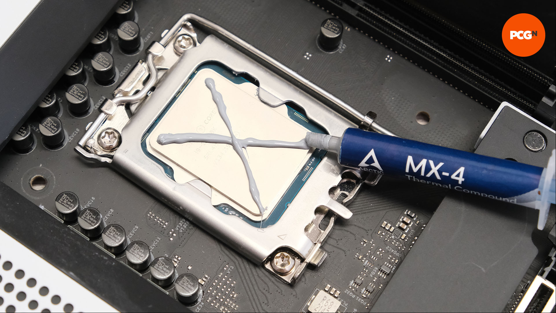 An X is drawn in thermal paste on the U sitting in the socket on the motherboard