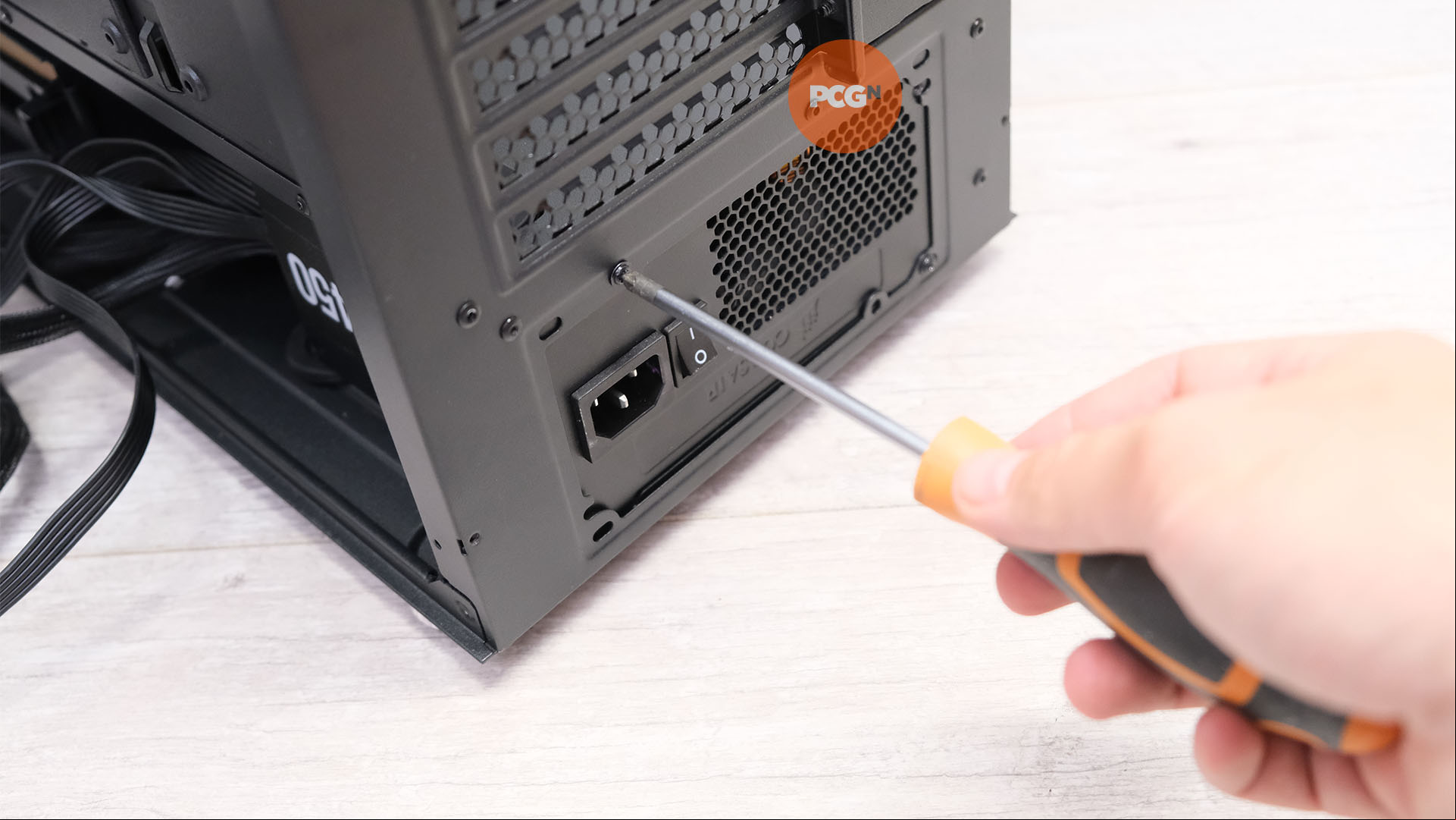 How to build a gaming PC: Screw PSU into case