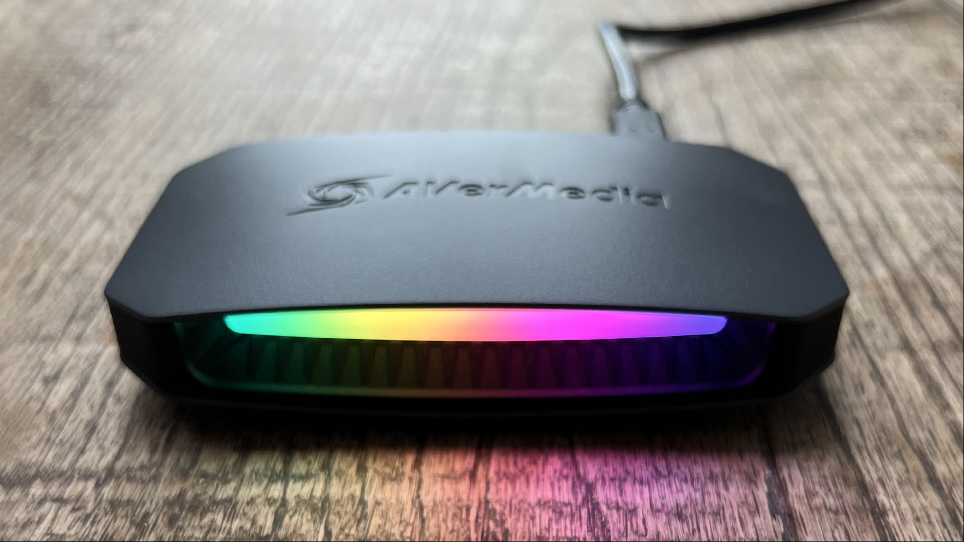 AverMedia Live Gamer Ultra 2.1 review image showing the device on a wooden surface.
