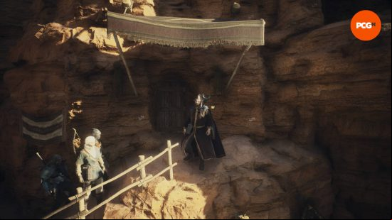 The Arisen and his pawns standing outside the Dragon's Dogma 2 house in Bakbattahl, which is inside a mountain.