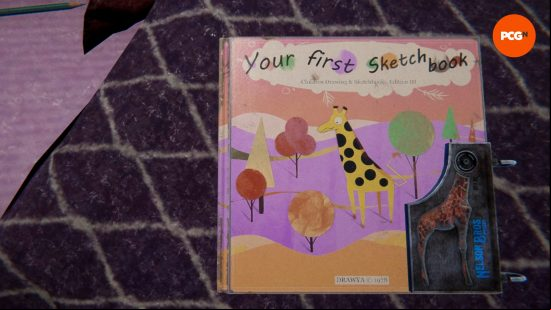 Dorie's locked sketch book sits on the bed in Reveil.