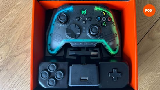 The Rainbow Pro 2 controller in it's box with additional thumbsticks, d-pad and the charging dock 