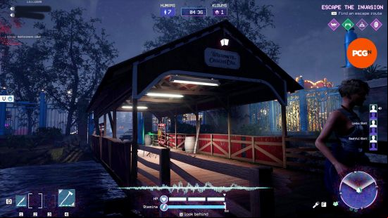 A player runs across the bridge, one of the Killer Klowns from Outer Space exits.