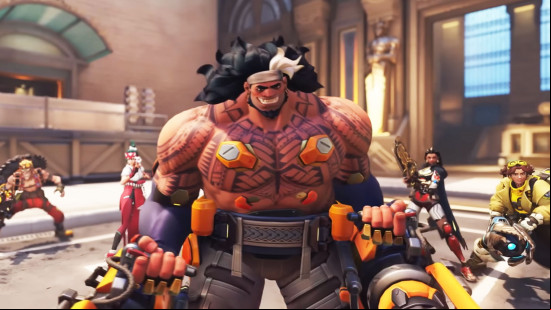 Best cross-platform games: Overwatch 2. Image shows a large, muscled, tattooed man holding weapons.