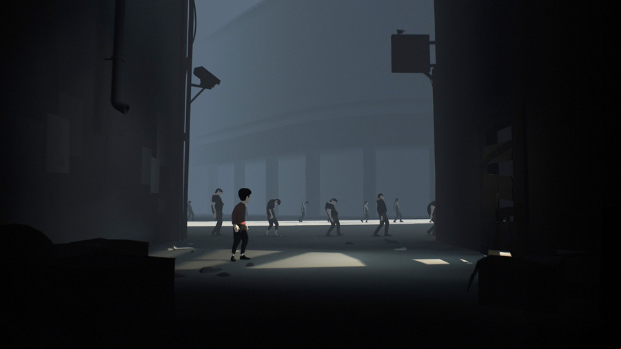 A young boy looks into the distance at zombified humans in Inside.