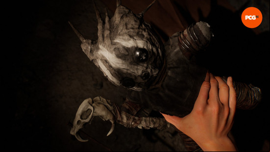 The Casting of Frank Stone: A hand holds a small doll made to look like The Wraith, one of the DBD killers.