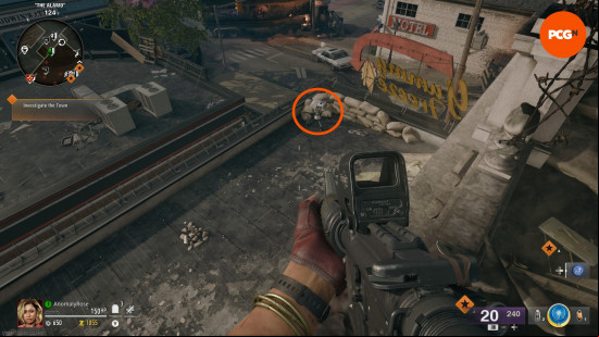 An orange circle highlights a white projector on the roof of Yummy Freeze in the Black Ops 6 Zombies Liberty Falls main quest.