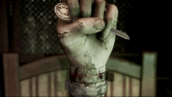A statue of a hand clutches onto a key and three bracelets sit on its wrist in the Silent Hill 2 hand puzzle.