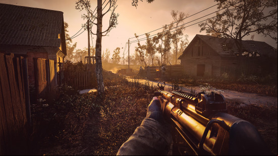 Stalker 2 preview: An image of the Exclusion Zone in the daylight, with a man holding an SMG.