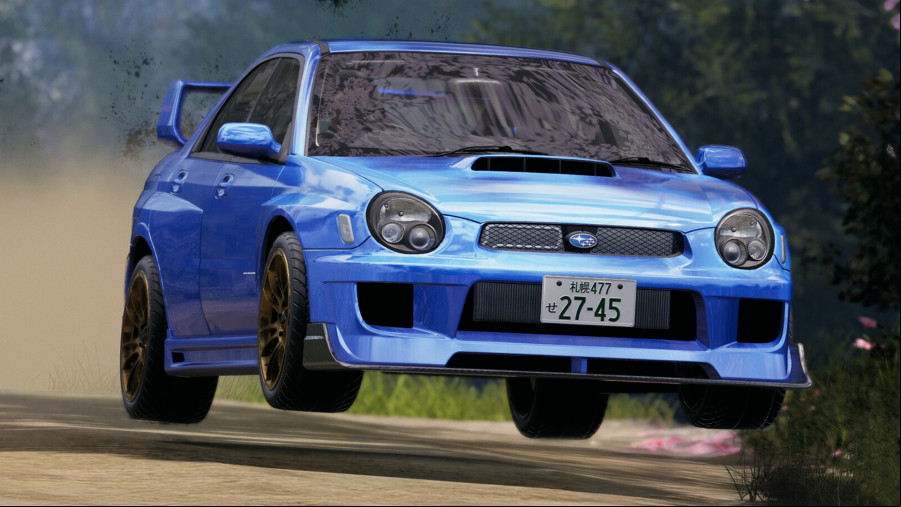 Japanese Drift Master: A blue Subaru gets air as it speeds along a track