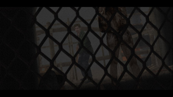 Camera peers through a chain mail fence as James faces a monster in Silent Hill 2. 