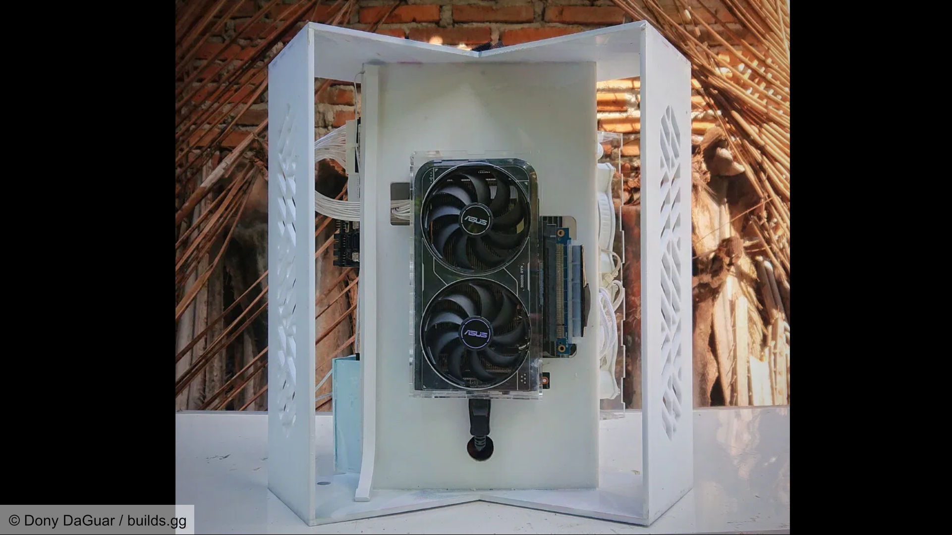 Futuristic space-like gaming PC build, internal section showing the graphics card and GPU riser cable.