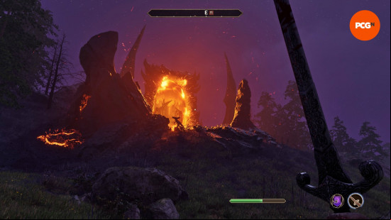 Oblivion review: An Oblivion Gate can be seen at the crest of a rocky hillside, its fiery glow lighting up the night sky.